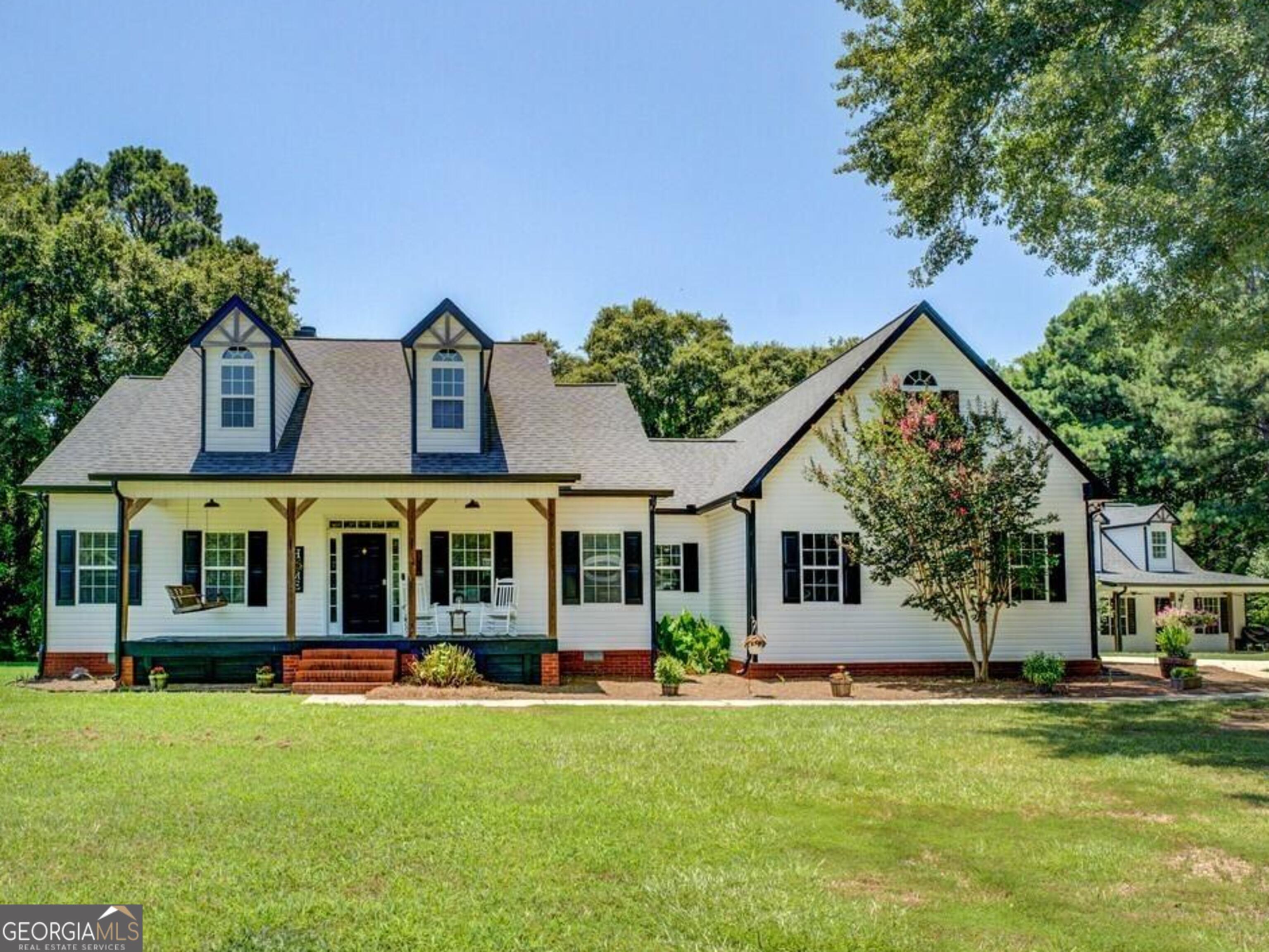 403 Chester Piper Road Covington, GA 30014 - Photo 1 of 1 a front view of a house with a yard table and garage