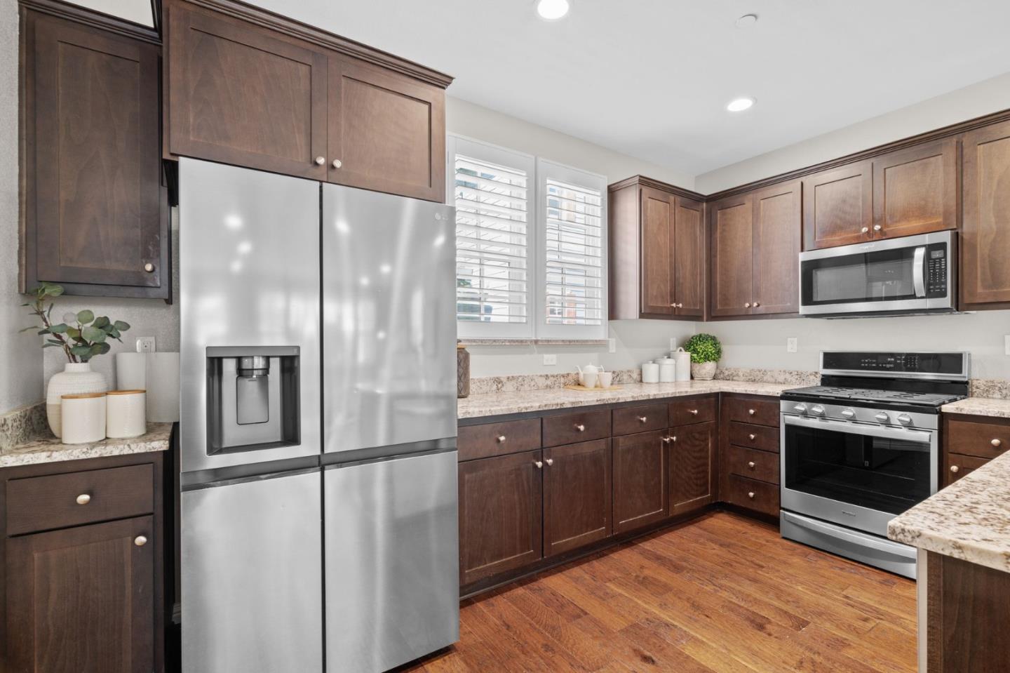 3406 Pyramid Way Mountain View, CA 94043 - Photo 8 of 41 a kitchen with stainless steel appliances granite countertop a refrigerator a stove a sink and a microwave