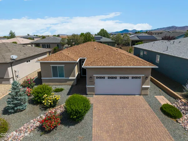 an aerial view of a house with a yard