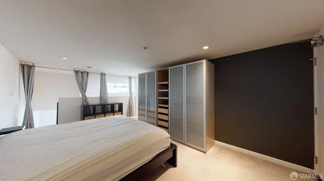 a large bedroom with a bed and a television in it