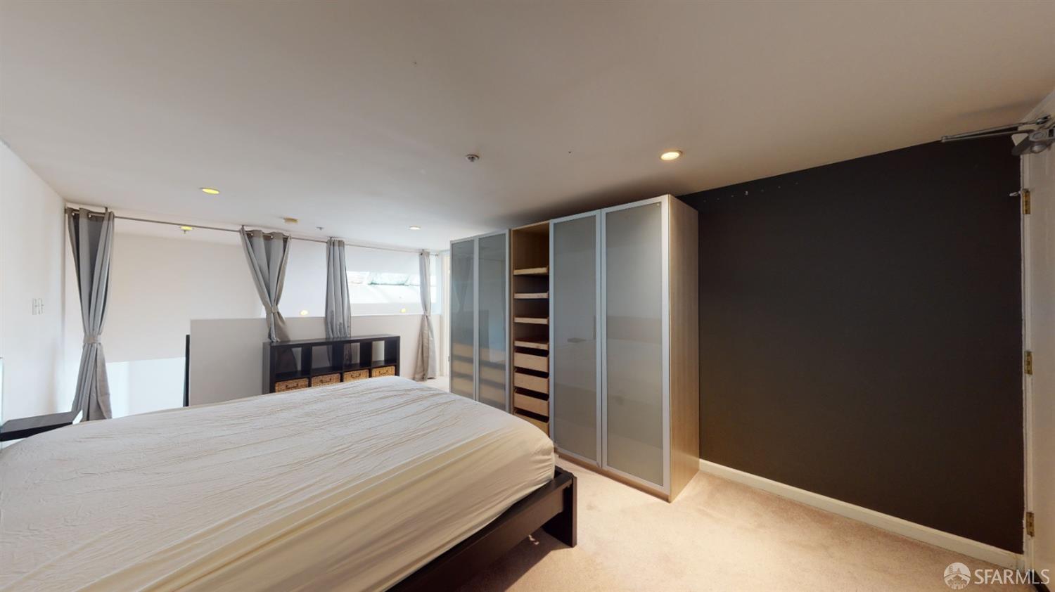 1578 Indiana Street, Unit 11 San Francisco, CA 94107 - Photo 18 of 23 a large bedroom with a bed and a television in it