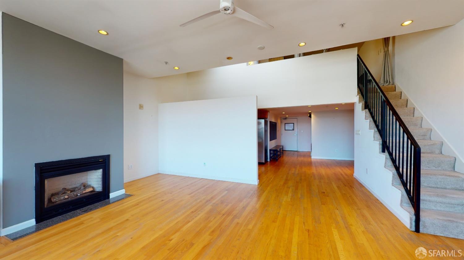 1578 Indiana Street, Unit 11 San Francisco, CA 94107 - Photo 6 of 23 a view of a hallway with wooden floor and a fireplace