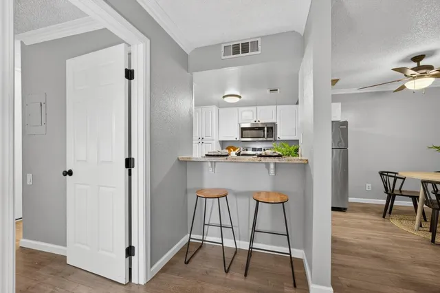 a kitchen with kitchen island a counter top space appliances and cabinets
