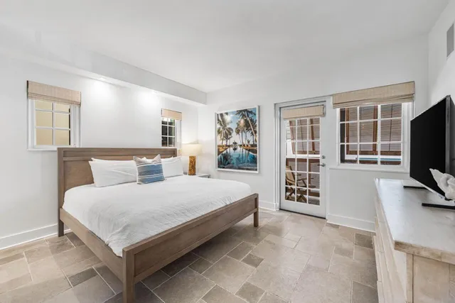 a living room with a bed and a flat screen tv