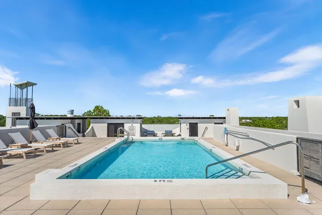 a view of house with swimming pool outdoor seating