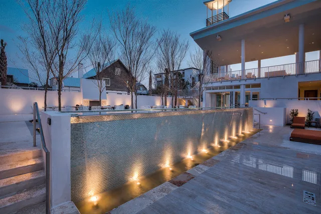 a view of a house with pool and sitting area