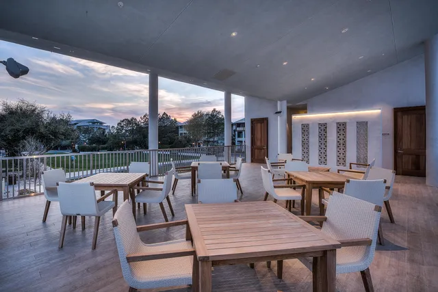 a dining room with furniture window and wooden floor
