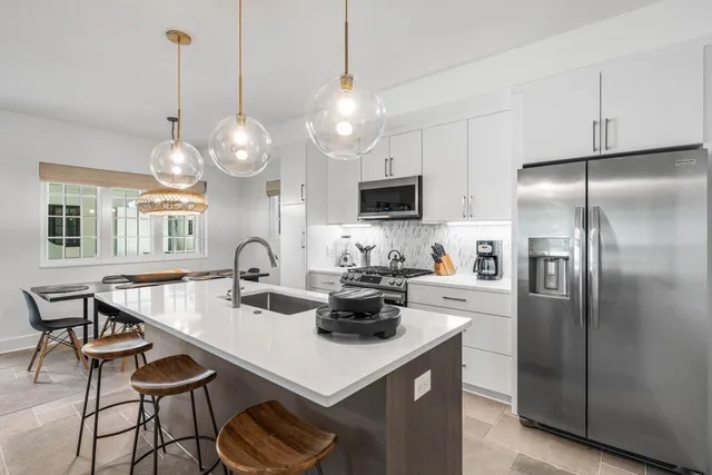a kitchen with refrigerator and cabinets