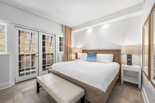 a bedroom with a large bed and a window