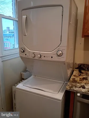 an empty room with stairs and windows