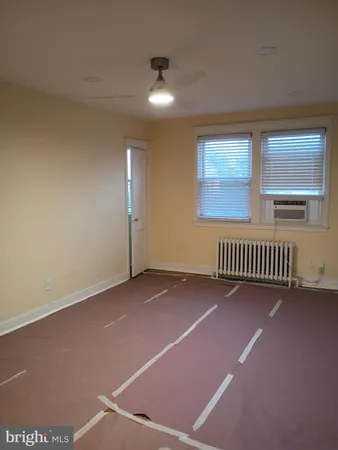 a view of an empty room with a sink and a potted plant