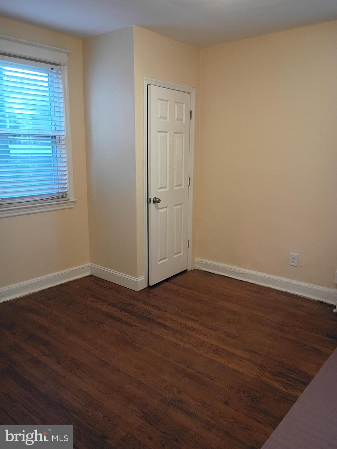 5220 4th Street Northwest, Unit 3 Washington, DC 20011 - Photo 9 of 10 a view of an empty room with wooden floor and a window
