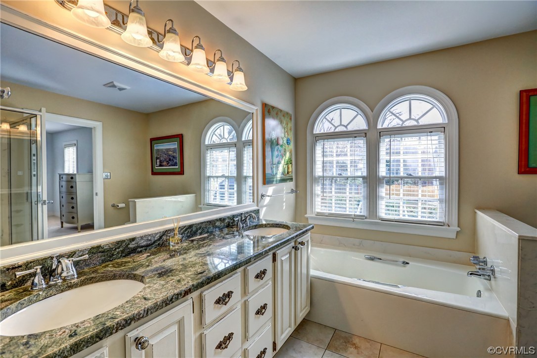 903 Baldwin Road Henrico, VA 23229 - Photo 35 of 46 a spacious bathroom with a granite countertop tub a double vanity sink and a large mirror