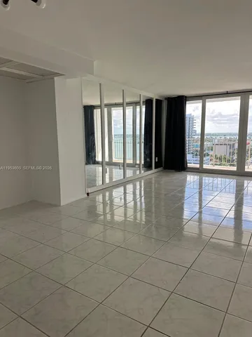 a kitchen with granite countertop a stove top oven microwave and cabinets