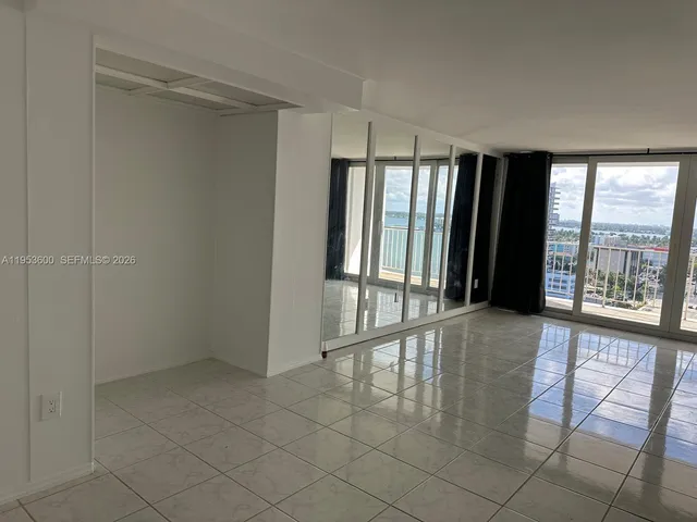 a kitchen with granite countertop a stove microwave and cabinets