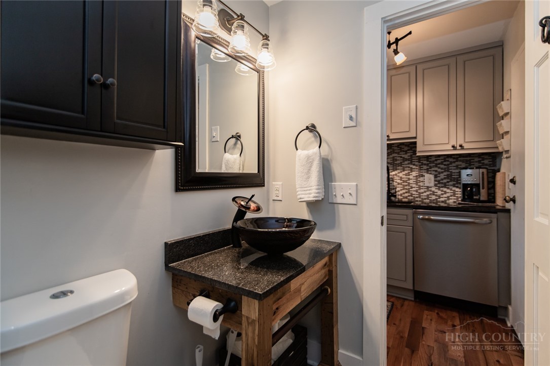 301 Pinnacle Inn Road, Unit 4103 Beech Mountain, NC 28604 - Photo 10 of 43 a bathroom with a granite countertop sink a toilet and mirror