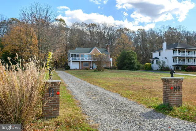a living room with furniture a fireplace and a window