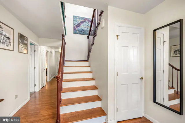 a living room with furniture a fireplace a large window and a flat screen tv