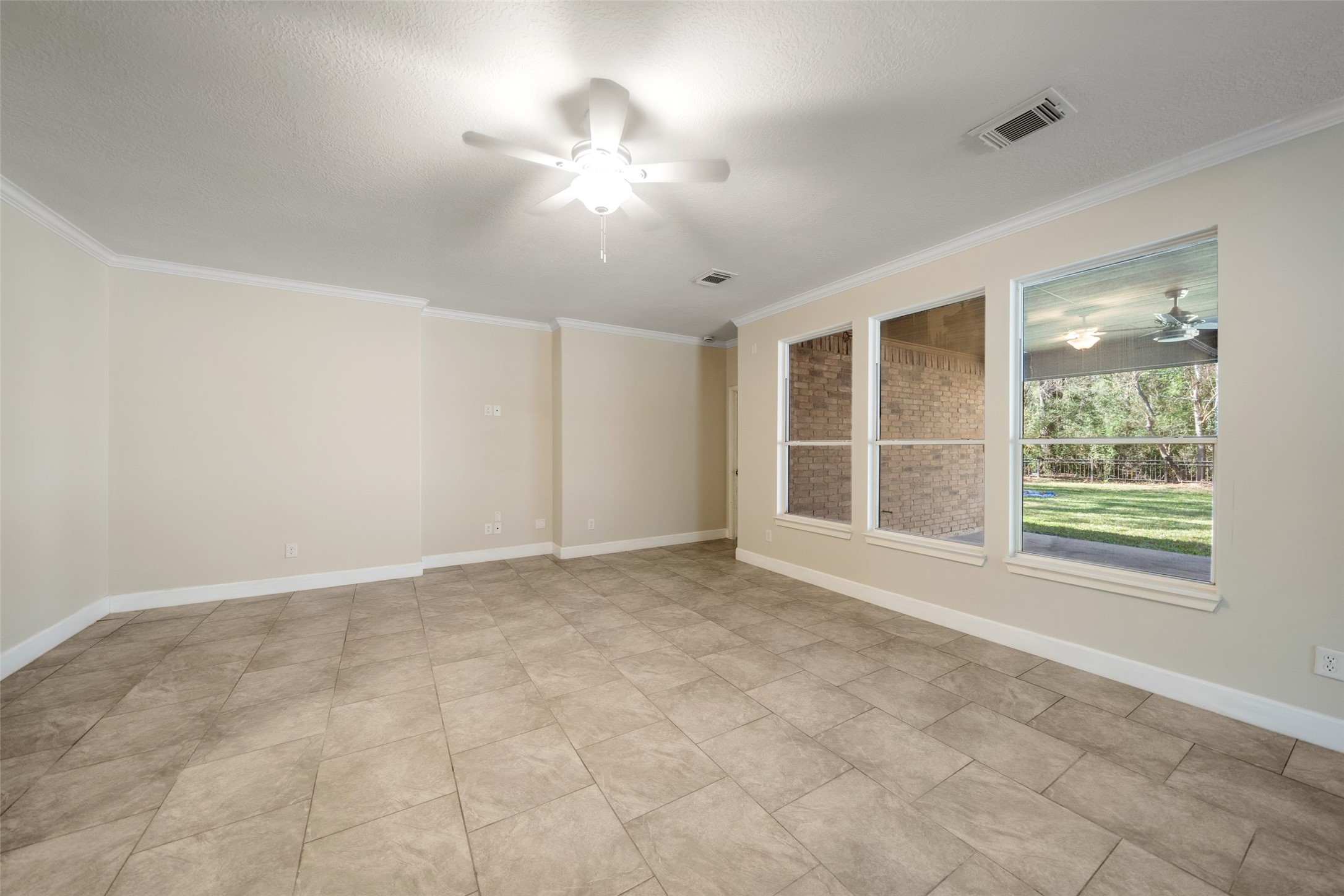 29627 Spring Forest Drive Spring, TX 77386 - Photo 12 of 29 Large windows looking out to covered porch and back yard.