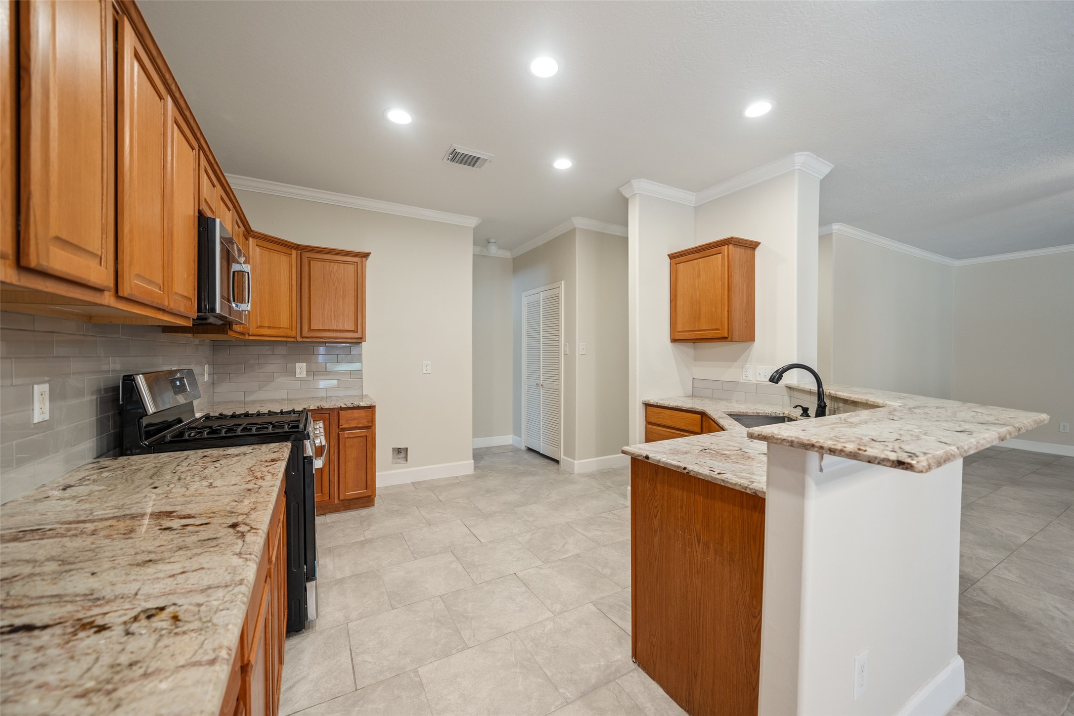 29627 Spring Forest Drive Spring, TX 77386 - Photo 13 of 35 a view of a kitchen with stainless steel appliances granite countertop a sink and cabinets