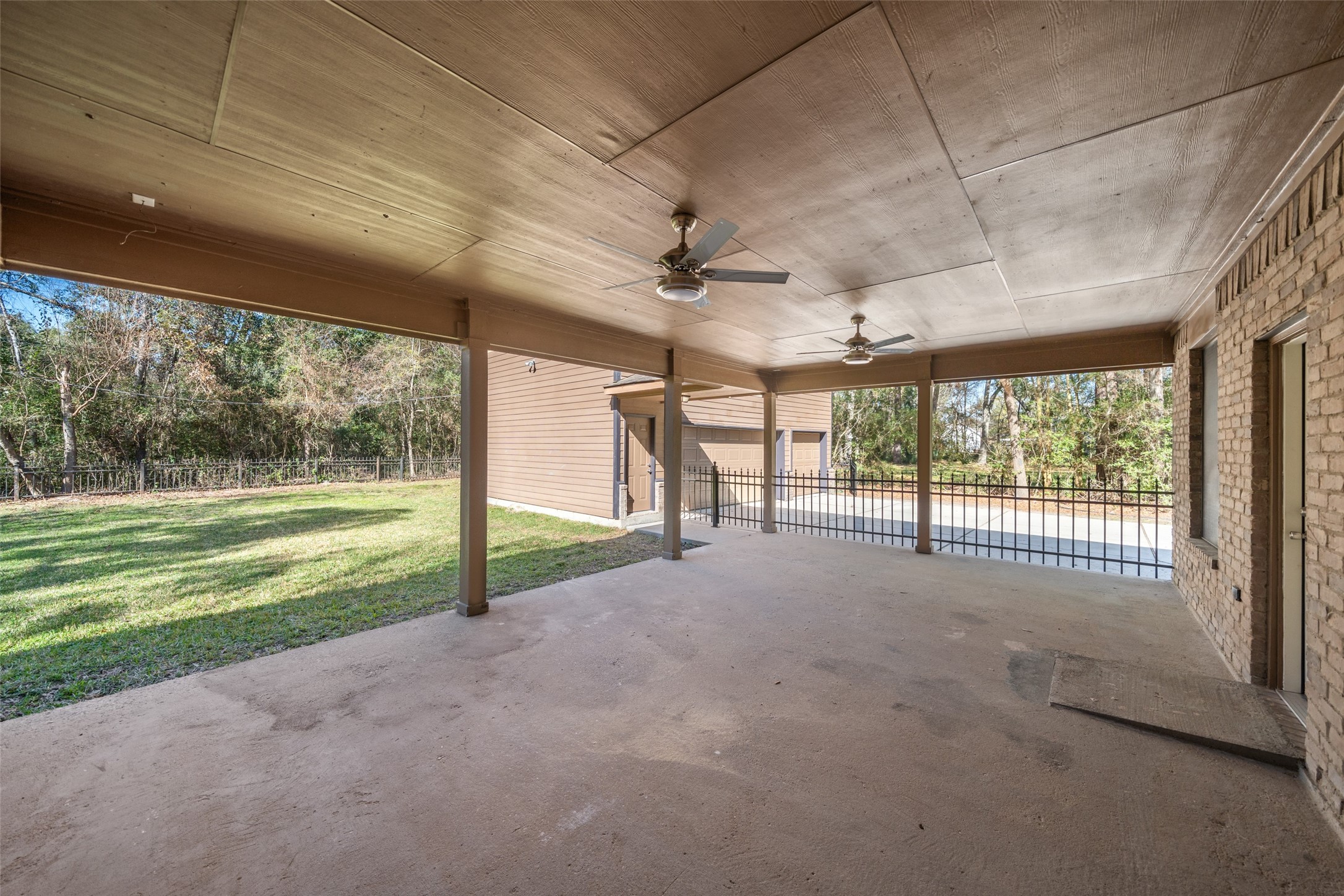 29627 Spring Forest Drive Spring, TX 77386 - Photo 23 of 29 Massive covered porch with 2 new ceiling fans and cement ramp to back door.