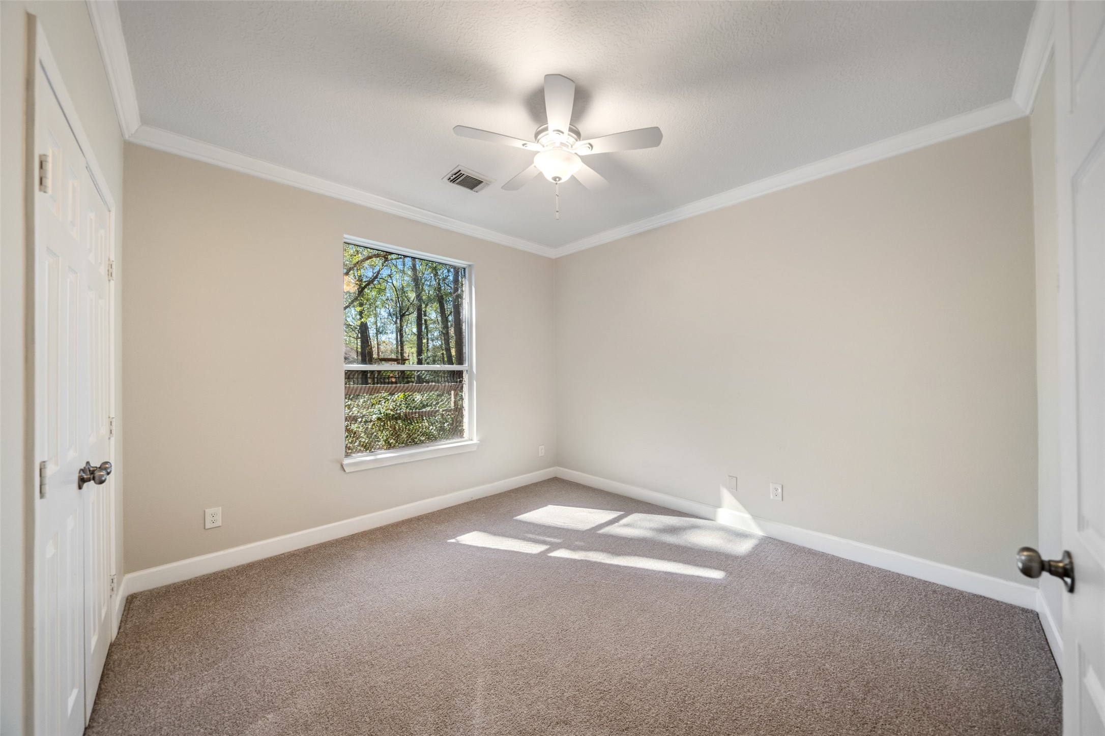 29627 Spring Forest Drive Spring, TX 77386 - Photo 25 of 35 an empty room with windows and ceiling fan