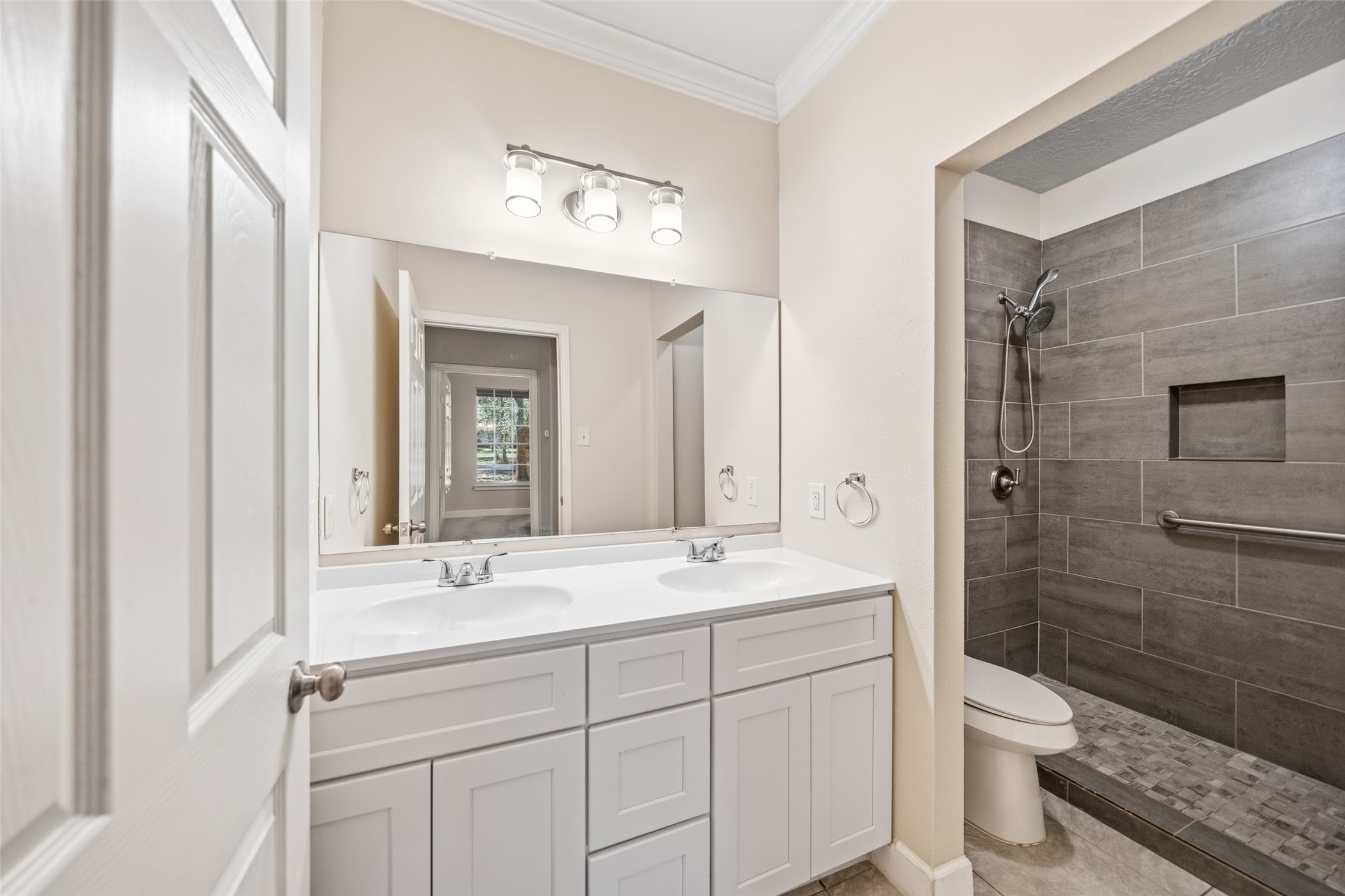 29627 Spring Forest Drive Spring, TX 77386 - Photo 26 of 35 a bathroom with a double vanity sink a toilet and a mirror