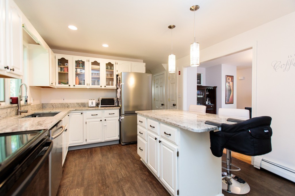 13 Pinewood Road Wellesley, MA 02482 - Photo 7 of 16 a kitchen with a sink stove and cabinets