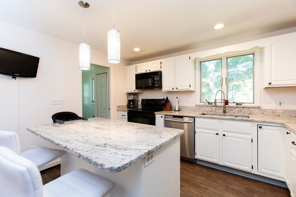 13 Pinewood Road Wellesley, MA 02482 - Photo 8 of 16 a kitchen with granite countertop a sink and a stove top oven