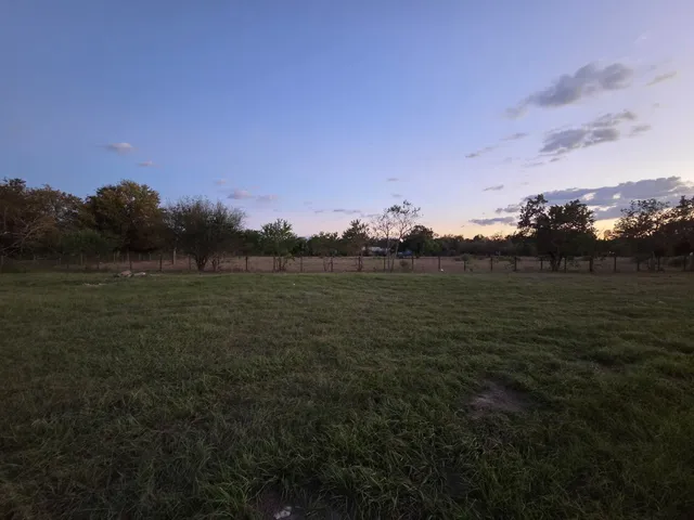 a view of a lake with houses in back