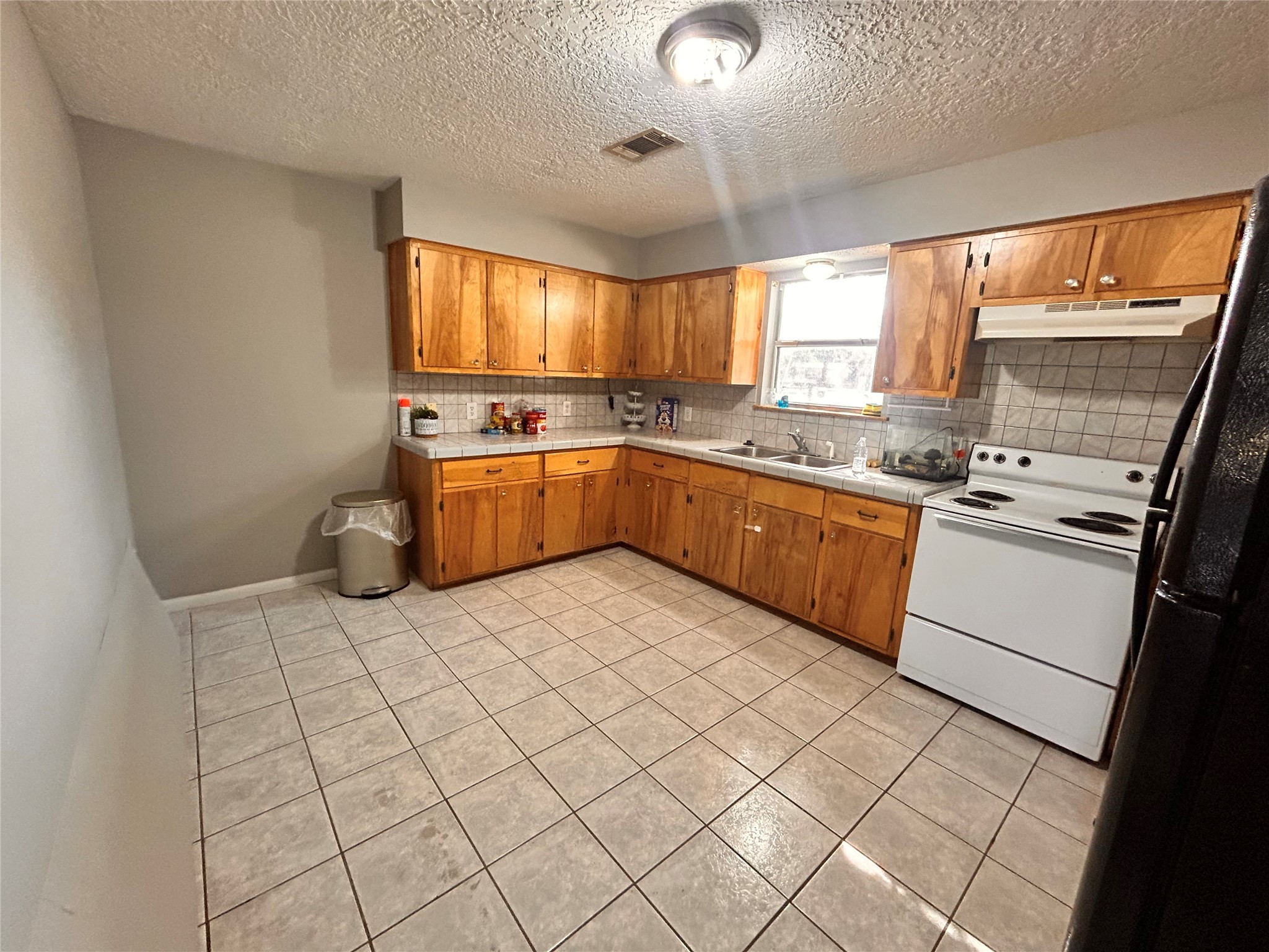 8118 Hamilton Road Brookshire, TX 77423 - Photo 7 of 22 a kitchen with a sink a stove top oven and cabinetry