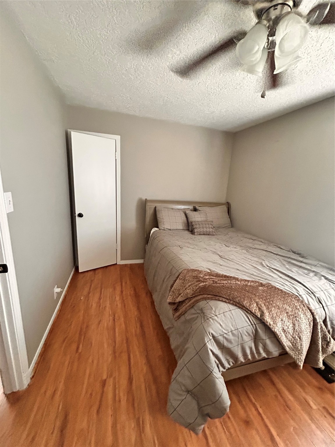 8118 Hamilton Road Brookshire, TX 77423 - Photo 8 of 22 a bedroom with a bed and wooden floor