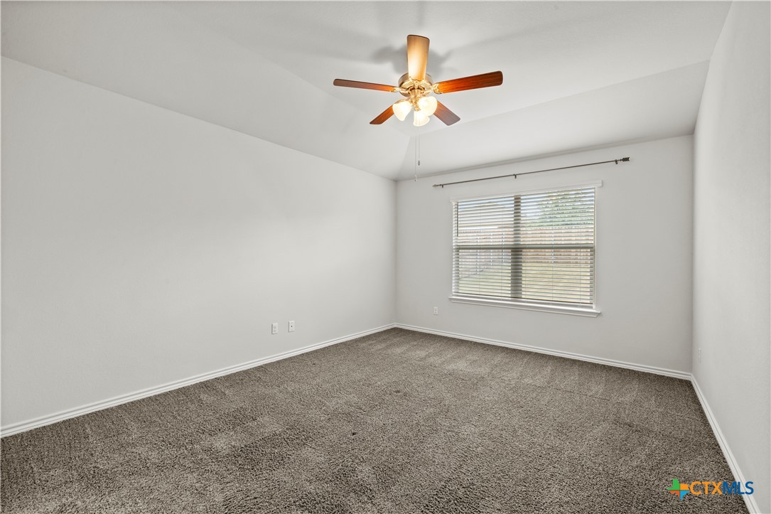 6243 Matagorda Road Belton, TX 76513 - Photo 16 of 27 an empty room with windows and fan