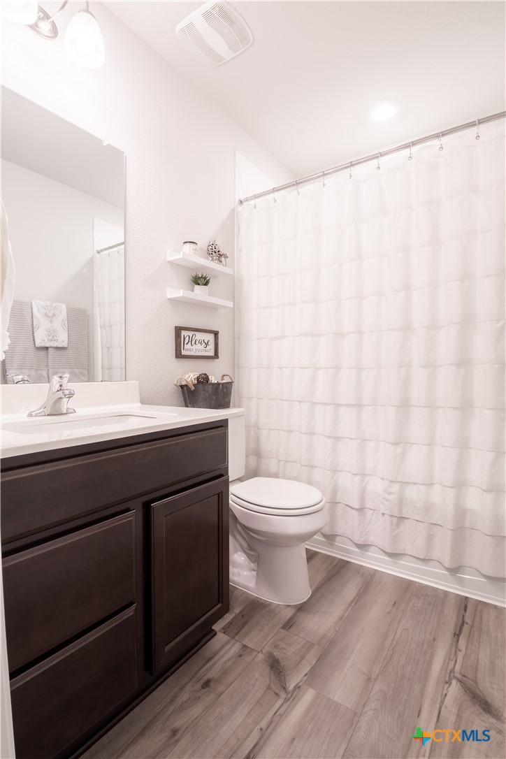 6243 Matagorda Road Belton, TX 76513 - Photo 17 of 27 a bathroom with a toilet a sink and a mirror