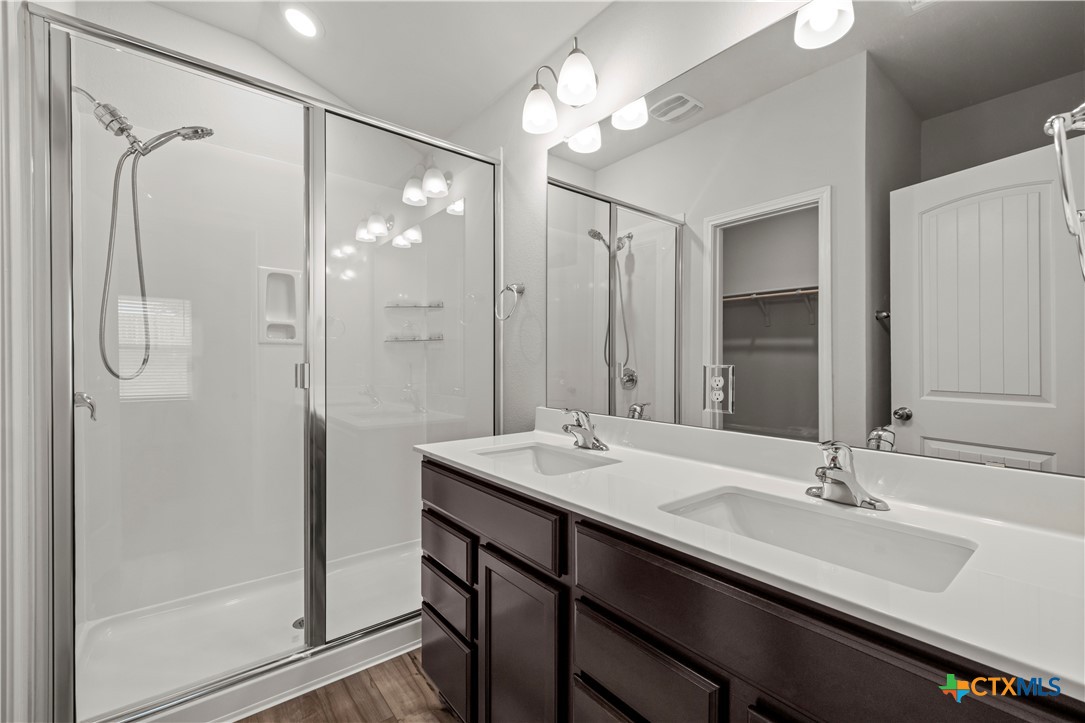 6243 Matagorda Road Belton, TX 76513 - Photo 19 of 27 a bathroom with a double vanity sink mirror and shower