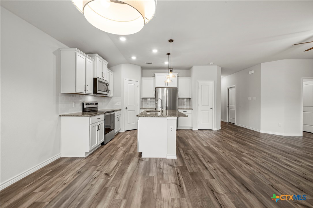 6243 Matagorda Road Belton, TX 76513 - Photo 7 of 27 a view of kitchen with cabinets microwave and stove