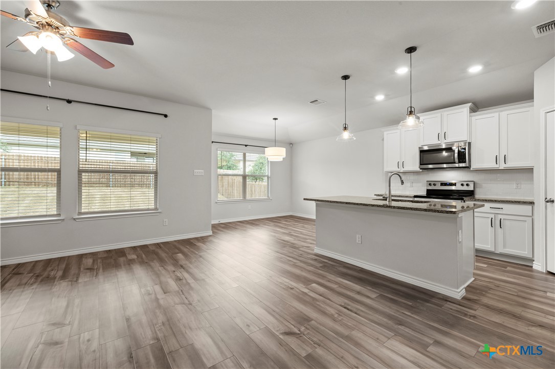 6243 Matagorda Road Belton, TX 76513 - Photo 10 of 27 a kitchen with stainless steel appliances a refrigerator sink and microwave