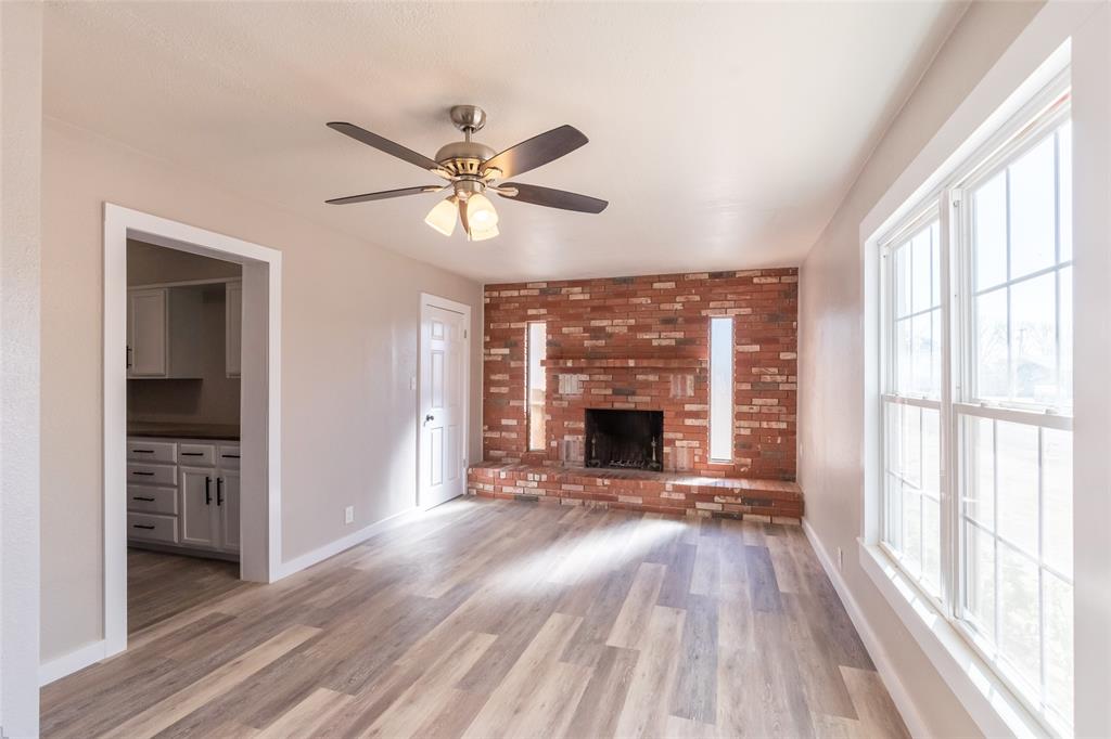 601 North Ave G Haskell, TX 79521 - Photo 9 of 36 a view of livingroom with hardwood floor and a ceiling fan