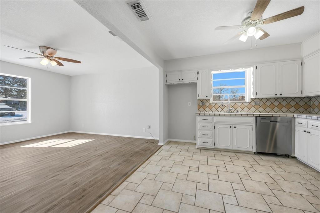 2611 Easy Street Denison, TX 75020 - Photo 11 of 32 a kitchen with a stove cabinets and window