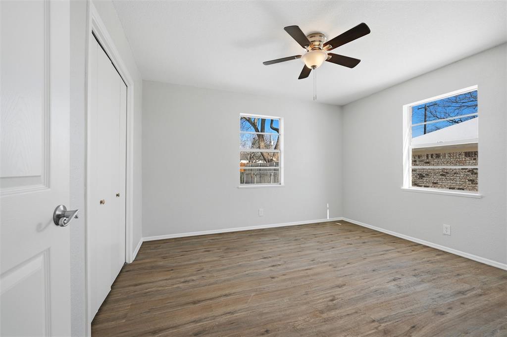 2611 Easy Street Denison, TX 75020 - Photo 16 of 32 an empty room with wooden floor and ceiling fan