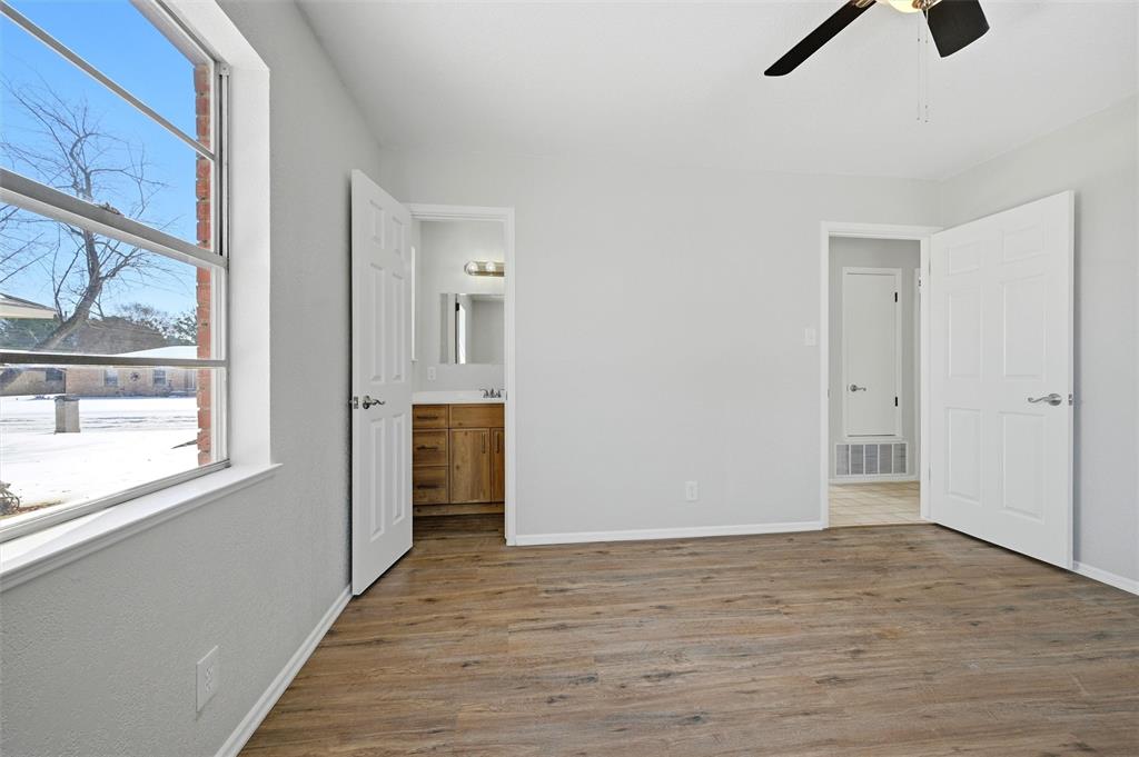 2611 Easy Street Denison, TX 75020 - Photo 18 of 32 a view of an empty room with a window and wooden floor