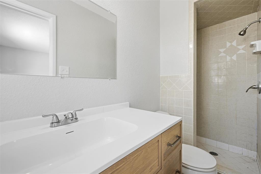 2611 Easy Street Denison, TX 75020 - Photo 20 of 32 a bathroom with a sink a toilet and shower
