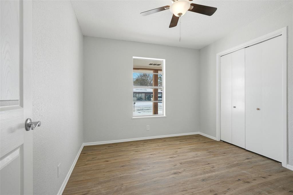 2611 Easy Street Denison, TX 75020 - Photo 21 of 32 an empty room with a window and a ceiling fan