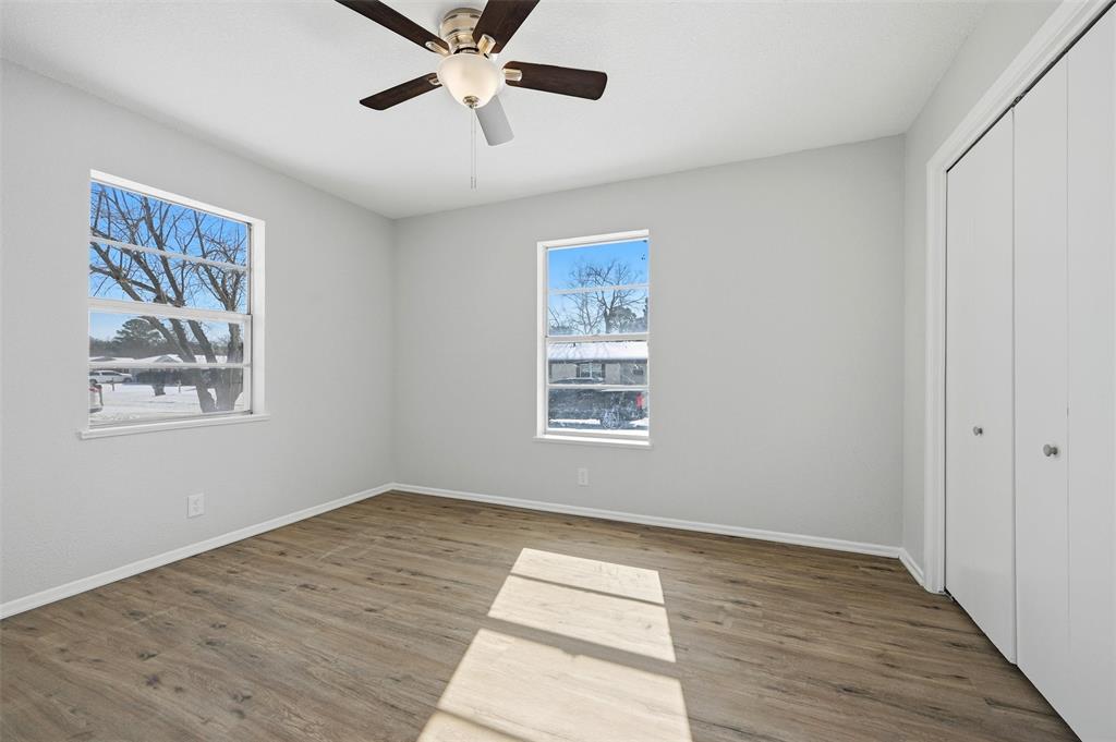 2611 Easy Street Denison, TX 75020 - Photo 24 of 32 a view of an empty room with wooden floor and a window