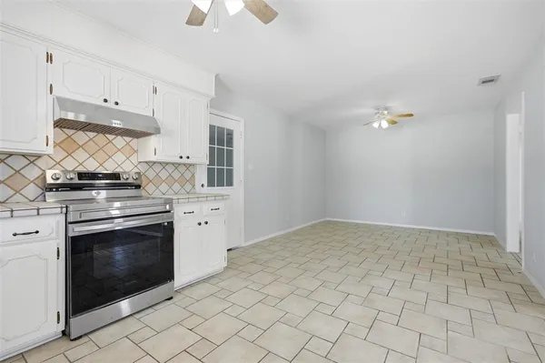 a kitchen with a stove and a sink