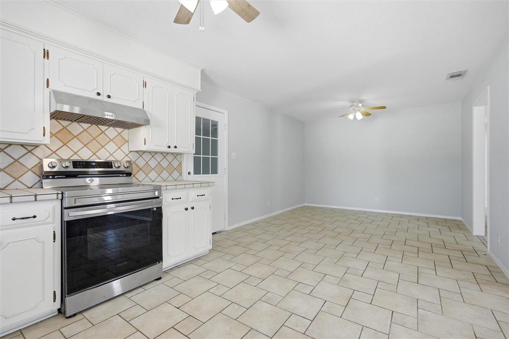 2611 Easy Street Denison, TX 75020 - Photo 9 of 32 a kitchen with a stove and a sink