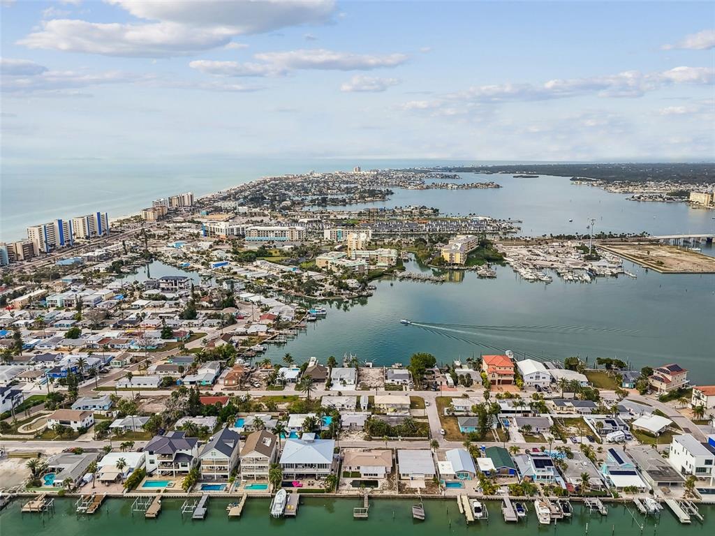 247 144th Avenue Madeira Beach, FL 33708 - Photo 23 of 29 an aerial view of a city with lots of residential buildings and ocean view in back