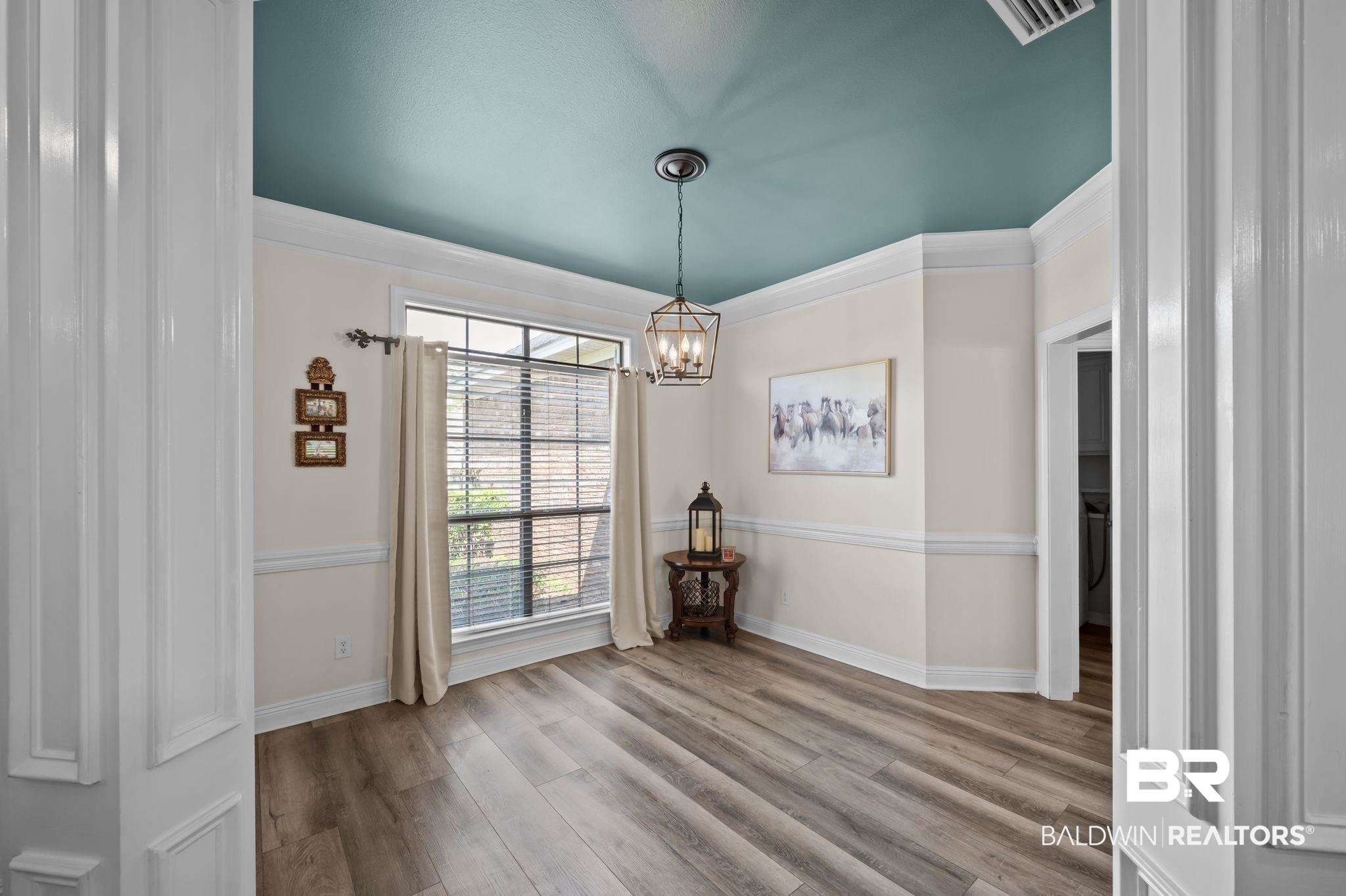 9837 Harmony Ridge Drive Semmes, AL 36575 - Photo 5 of 29 Unfurnished dining area with visible vents, wood finished floors, a chandelier, and crown molding
