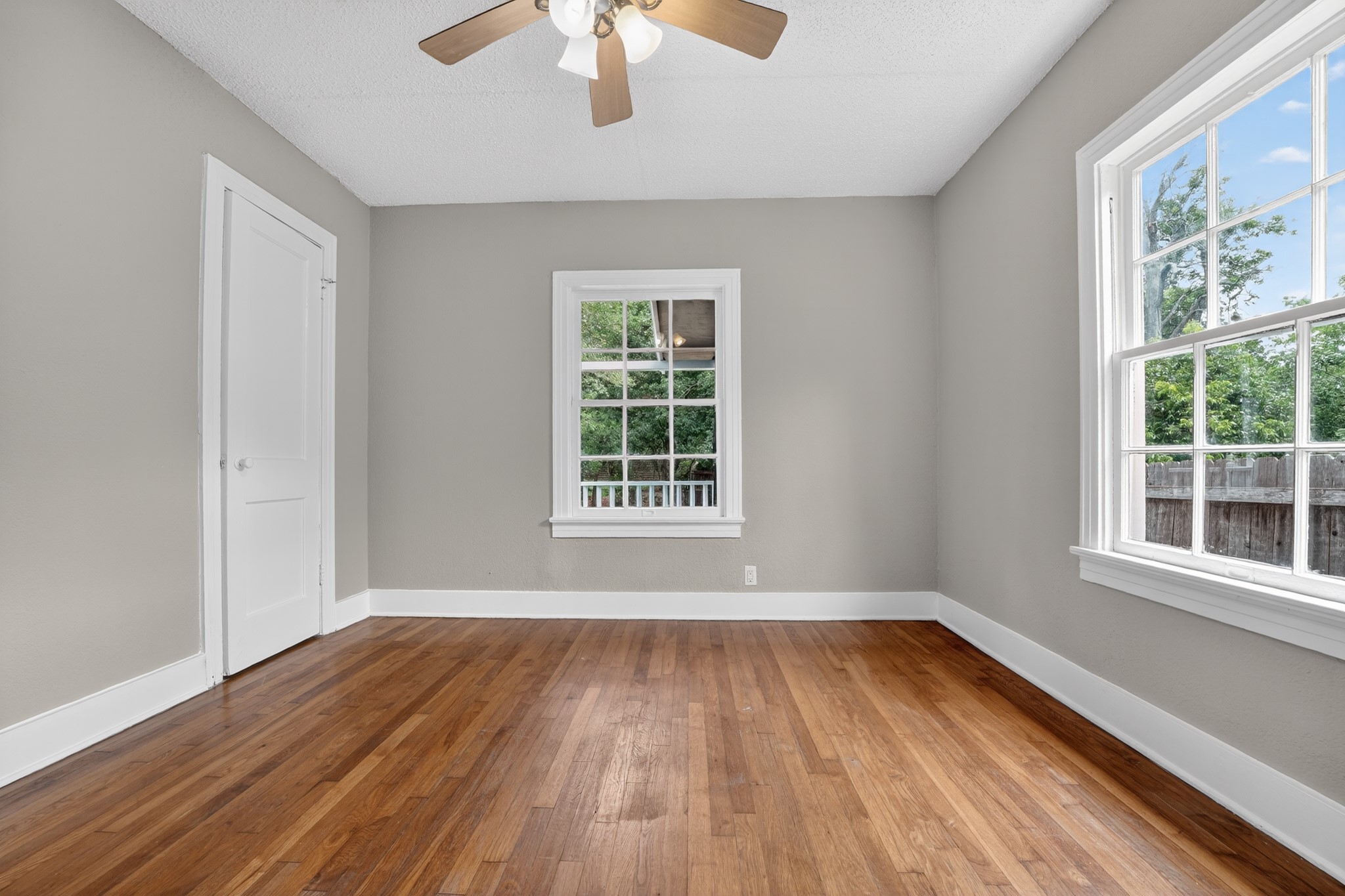 4907 Duval Street Austin, TX 78751 - Photo 16 of 31 a view of an empty room with wooden floor and a window