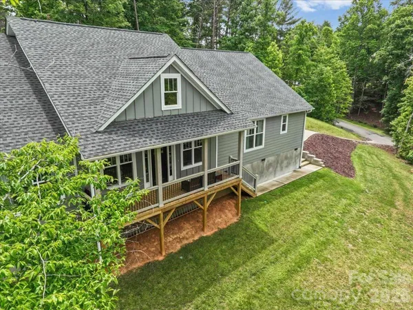 aerial view of a house with a yard patio and a garden